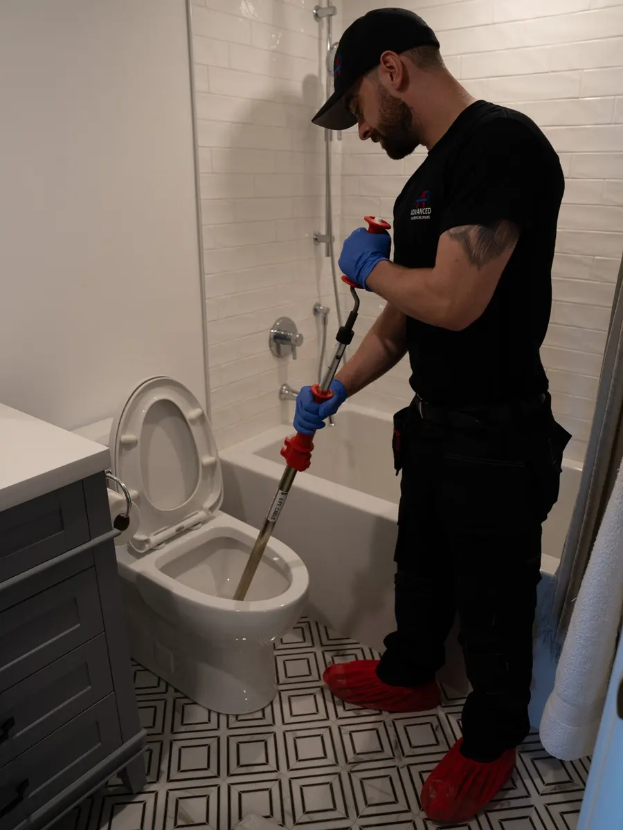 Clearing a clogged toilet with a toilet auger