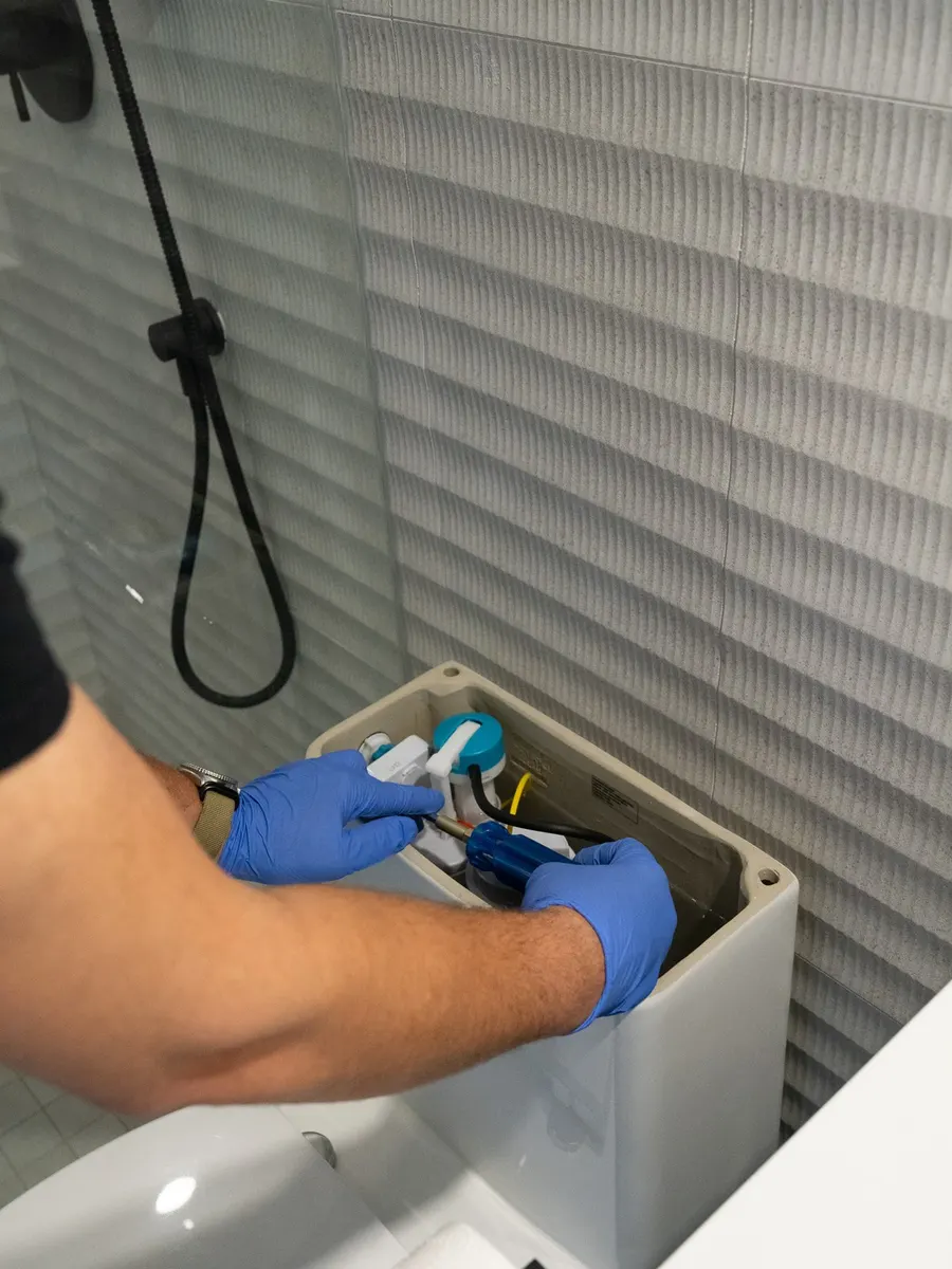 Adjusting the fill valve inside a toilet tank