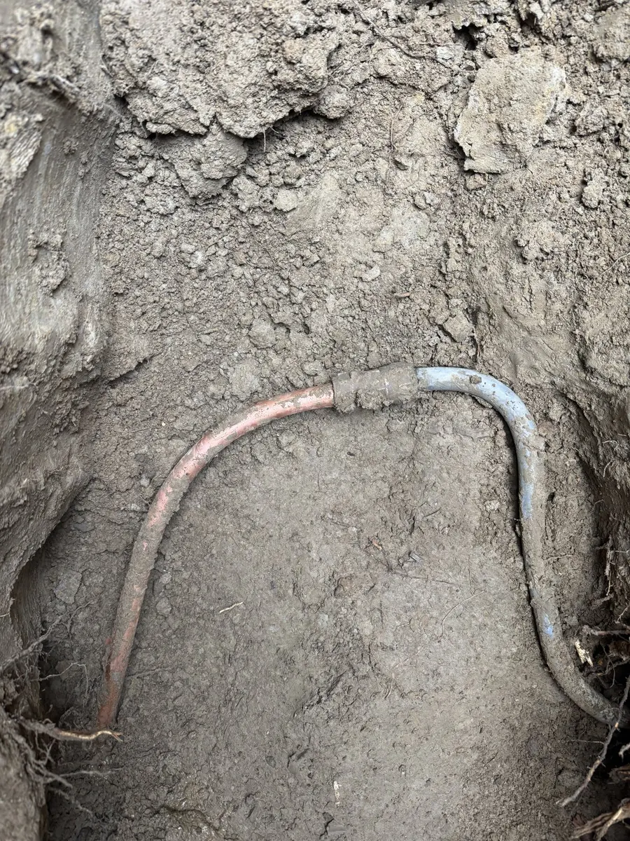 Old water service line exposed during excavation
